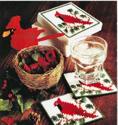 the table is set with three coasters and two glasses, one has red berries on it