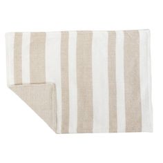 a beige and white striped towel folded on top of a tablecloth with an open pocket