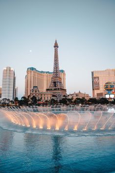 the eiffel tower is lit up in front of the las vegas hotel and casino