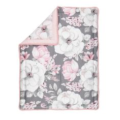 the pink and grey floral blanket is folded up