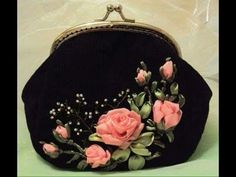 a black purse with pink flowers on it