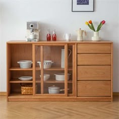 a wooden cabinet filled with dishes and cups