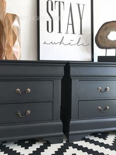 two black dressers with drawers and pictures on the wall