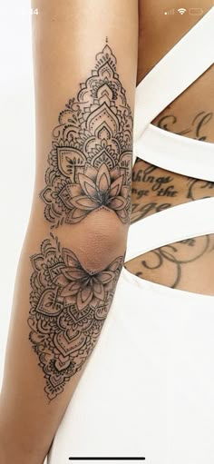 a woman's arm with tattoos on it and an image of the back of her body