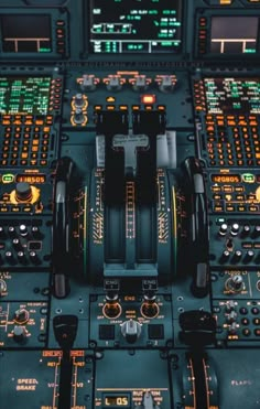 the cockpit of an airplane with many controls and lights on it's sides, as seen from above