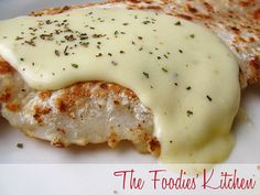 a piece of chicken covered in sauce on a white plate with the words the foodies kitchen written below it