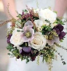 the bride's bouquet is made up of white and purple flowers