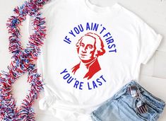 Show up to your 4th of July celebrations with this funny George Washington "If you ain't first, you're last" t-shirt.  Info for the shirts:*  Incredibly comfortable Bella + Canvas*  Choose your shirt color:  white, gray, or black*  Red and blue graphic*  Unisex sizingMake sure to check out our shop for other items like decor, photo booth props, and wine glasses!Thank you for stopping by ZAM Handmade Market.  Please let us know if you have any questions. 4th Of July Shirts For Women, July 4th Shirts Vinyl, 4th Of July T Shirt Ideas, You Look Like The 4th Of July, Olympic Outfits, Funny Short Sleeve Tops For 4th Of July, Fun 4th Of July Shirt With Letter Print, 4th Of July T Shirts, Funny 4th Of July Shirts