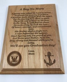 a wooden plaque with an image of the us marine seal and anchor on it that reads, a boy no more