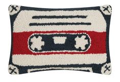 a pillow with an old school cassette pattern on the front and sides, in black, white, red and blue