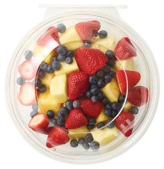 fruit salad in a plastic container on a white background