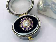 A Beautiful Old 9 karat Gold, Pearl & Purple Amethyst Flower Cluster Halo Ring. A beautiful quality early English made fine gemstone ring circa 1940 - 1960. Hallmarks: 'J&J' English maker circa 1890- 1960 '375' for 9 karat yellow Gold and London assay office marked.  This beautiful antique ring is Victorian style and was fashioned as a classic Edwardian statement jewel. The ring has a central snow white freshwater pearl (drilled to the back) surrounded by 10 flush-set round cut mid purple amethy Antique Amethyst Birthstone Ring, Victorian Style Amethyst Ring Stamped 14k, Victorian Style 14k Stamped Amethyst Ring Gift, 14k Stamped Amethyst Wedding Ring, Flower Halo Engagement Ring, Gold Solitaire Engagement Ring, Nature Inspired Engagement Ring, Precious Rings, Gold Promise Rings