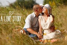 a man and woman are sitting in the tall grass with their arms around each other