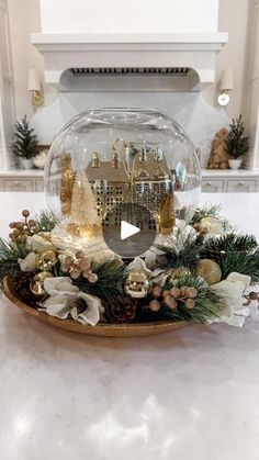 a glass bowl filled with christmas decorations on top of a counter