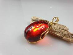 Deep Red amber pendant. Perfect stunning ruby red teardrop shape. Gold plated pendant (with stamping-hallmark). High quality. Teardrop shape elegant pendant. All natural parts, not plastic. Weight: 14.00 gr Pendant size: 5.5 x 2.6 cm MATCHING Earrings: https://www.etsy.com/uk/listing/912802337/ruby-red-amber-earrings-gold-plated?ref=shop_home_active_4&frs=1 This item was made of natural Baltic Amber. All the amber used in my jewelry is collected in my home country Lithuania. I sell only genu Red Drop Beads For Jewelry Making, Cabochon Drop Jewelry For Gifts, Red Drop Gemstone Jewelry, Red Gemstone Drop Jewelry, Red Drop-shaped Jewelry For Gift, Red Drop Jewelry For Gift, Red Cabochon Round Pendant Jewelry, Red Teardrop Gemstone Jewelry, Ruby Cabochon Pendant Jewelry