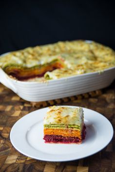 a piece of cake sitting on top of a white plate next to a casserole dish