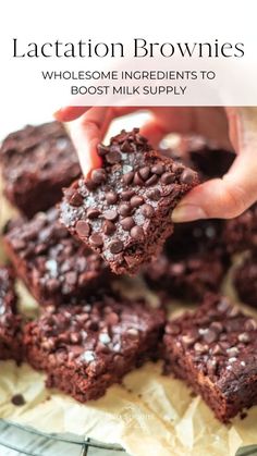 chocolate brownies are stacked on top of each other and being held by someone's hand