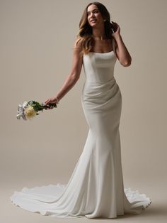 a woman in a wedding dress holding a bouquet