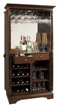 a wooden cabinet filled with lots of bottles and glasses