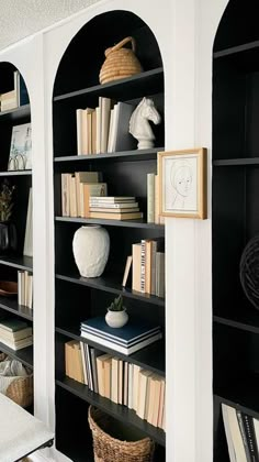 the bookshelves in this room are full of books and vases on them