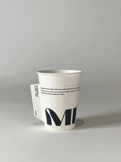 a coffee cup sitting on top of a white table