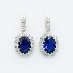 Blue Sapphire Earrings set with a Created Sapphire in a flawless diamond cut & royal blue color, at 14x10mm, 12 Carats a pair. Surrounded with Created CZ Diamonds. Princess Diana Earrings made of Solid 925 Sterling Silver ☞ made to last. Matching Ring: www.etsy.com/listing/254846009 Matching Pendant: www.etsy.com/listing/542319598 D E T A I L S ✓ Adina Stone GIFT BOX provided ♕ GUARANTEE on materials ♕ Hallmark on each piece ✓ Stone: Created Sapphire, 14x10mm, 12 Carats a pair ✓ More Beautiful j Diana Earrings, Royal Blue Earrings, Blue Sapphire Earrings, Flawless Diamond, Matching Rings, Sapphire Necklace, Sapphire Earrings, Earrings Blue, Cz Diamond