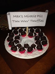 cupcakes are arranged on a plate with a sign