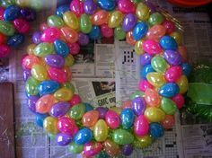 a wreath made out of balloons sitting on top of a newspaper