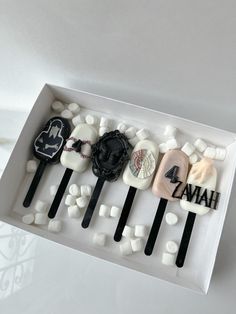 there are four different types of hair clips in a box with marshmallows