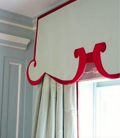 the red and white curtains are hanging on the window