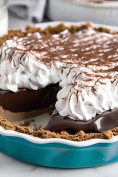 a pie with chocolate and whipped cream on top