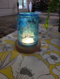 a blue mason jar sitting on top of a table