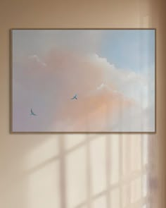 two birds are flying in the sky above a window with light coming from it's panoramic windows