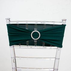 the back of a chair with a ring on it's seat cushion and green fabric