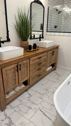 a bathroom with two sinks and a bathtub