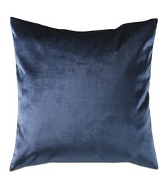 a blue velvet pillow on a white background