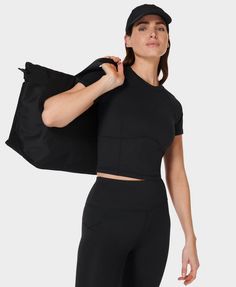 A new, shorter tee for studio workouts. Lightweight fabric is soft, sweat-wicking and 80% recycled. Slim fit in a crop cut with a crew neck and short sleeves. Cropped length sits at the top of your leggings. Logo detailing across the back. Front length: 47cm / 18.5". Model wears size S and is 178cm/5'10" tall. Style Code: SB9798Colour: Black T Shirt Frame, Recycled T Shirts, Crop T Shirt, Sweaty Betty, Kids Swimwear, Cropped T Shirt, Crop Top Sweater, Cropped Tee, Crop Tshirt