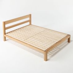 the bed frame is made out of wood and has no sheets on top of it