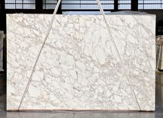 a large marble slab in a warehouse with metal handles on the front and back ends