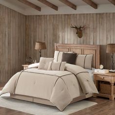 a large bed in a room with wooden walls