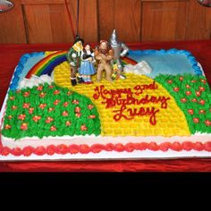 a birthday cake decorated with legos and characters