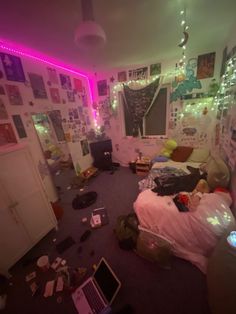 a messy room with lots of clutter on the floor and lights hanging from the ceiling