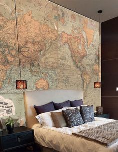 a bedroom with a large map on the wall above the bed and nightstands in front of it