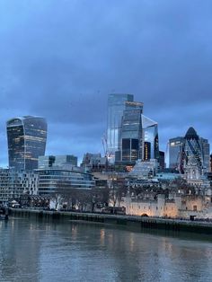 the london skyline is lit up at night