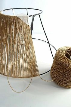 a ball of yarn next to a lamp shade