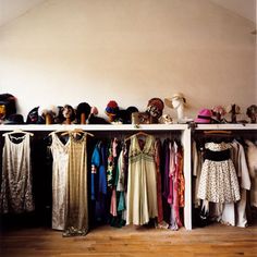 an assortment of dresses and hats are on display