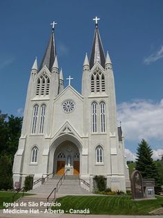 an old church with two steeples and a clock on the front door is shown