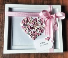 a white box with a pink heart shaped decoration