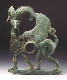 an old bronze figurine with a horse on it's back