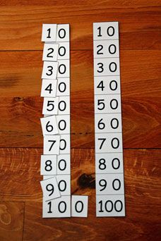 two numbers are placed on top of each other in front of a wooden floor with one number missing